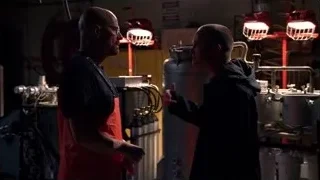 two men conversing in dimly lit workshop — Breaking Bad