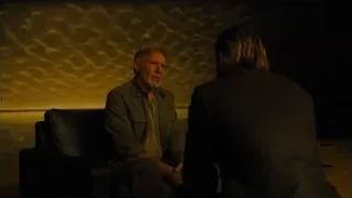 man deep in thought with woman standing — Blade Runner 2049
