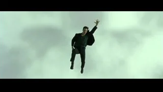 man in mid-air above city building — The Matrix