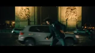 man in suit walking on street at night — John Wick: Chapter 4