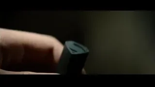 hand holding black electronic device — Superman: Man of Steel