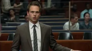 young man in suit standing in courtroom — Suits