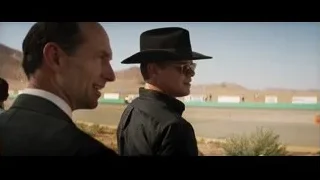 Two men standing in desert with mountains — Ford v Ferrari