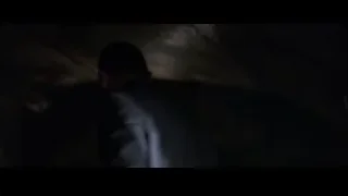person standing in dark tunnel with window — Batman