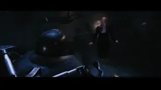 woman with red hair facing robot in dark room — Iron Man