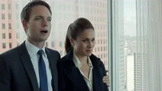 Man and woman looking at city skyline — Suits