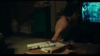 Person in tank top in dimly lit room — Joker