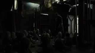 man with sword addressing people in dark room — Blade Runner 2049