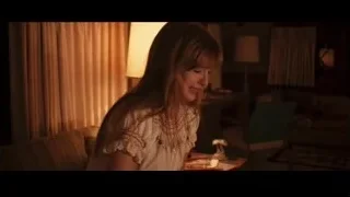 young woman smiling on couch in dim room — Jobs