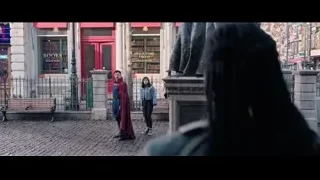 three people talking on a street, man with sword — Doctor Strange 2