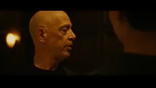 bald man speaking in dimly lit room — Whiplash