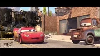 Lightning McQueen car by large black vehicle — Cars