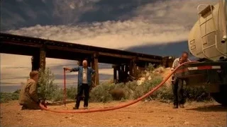 men working with hose and tanker truck — Breaking Bad
