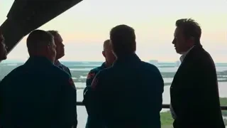 men talking in front of city skyline sunset — Elon Musk: Return to Space