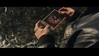 hand holding playing card with skull design — Now You See Me