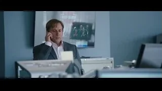 man and woman on couch in dim room — The Big Short