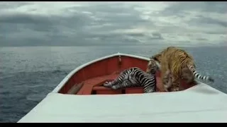 Two tigers on red boat in ocean — Life of Pi