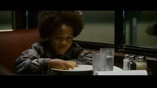 young boy eating pizza in restaurant — The Persuit of Happyness