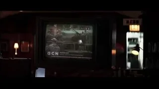 old TV displaying news program in dimly lit bar — Batman: The Dark Knight