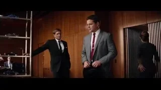 two men in suits by bookshelf — Ford v Ferrari