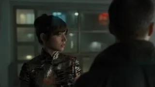 woman in Chinese dress with man by window — Blade Runner 2049