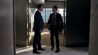 man in suit walking through open door — Suits