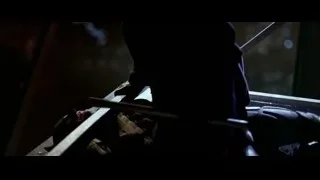 Joker in purple suit crouching on bench — Batman: The Dark Knight