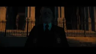 elderly man meditating in front of building — John Wick: Chapter 4