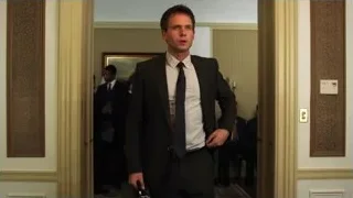 man in suit walking through hallway — Suits