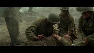 Soldiers carrying wounded person in wooded area — Hacksaw Ridge