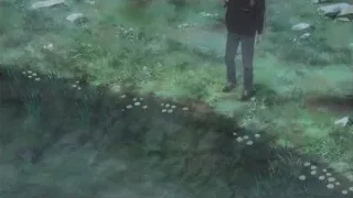 young man walking through grassy field — Your Name