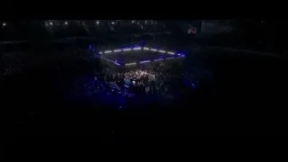 large arena with a lit stage — Creed