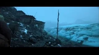 person walking on snowy mountain with wooden structure — Batman