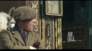 Man in suit petting white horse — Peaky Blinders