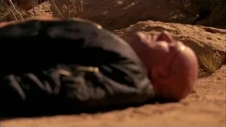 Man sleeping on rocky desert ground — Breaking Bad