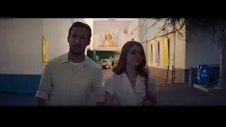 man and woman walking on street — La La Land