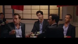 man in suit in front of red curtain — The Big Short