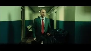 two men standing in a hallway — Limitless