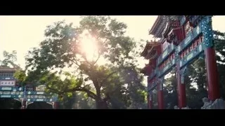 people walking by large Chinese archway — The Karate Kid