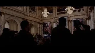 man at podium in grand hall — Creed