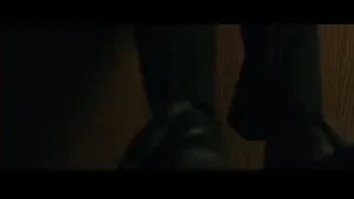 bloody person lying on a dark room floor — John Wick