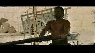 Shirtless man holding long pole outdoors — Gladiator 2