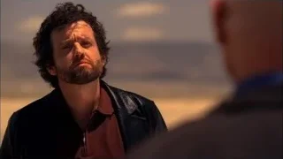 Man in leather jacket standing in desert — Breaking Bad