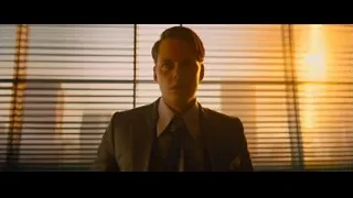 Man in suit by window with blinds at sunset — John Wick: Chapter 4