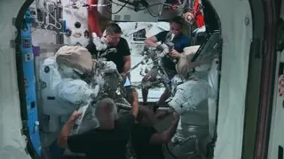 astronauts working on robotic arm in space station — Elon Musk: Return to Space