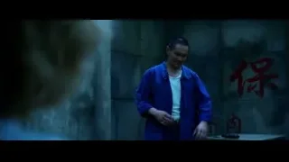man in blue jumpsuit holding gun — Lucy