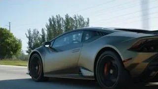 white car's rear end driving on road — Sports Cars