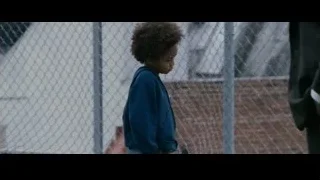young boy in front of chain-link fence — The Persuit of Happyness
