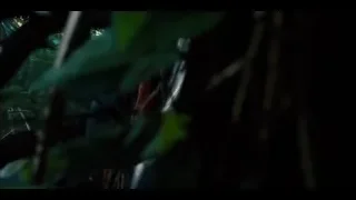 Young man looking at car debris in jungle — Jurassic World