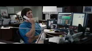 man on phone at desk with monitors — The Big Short